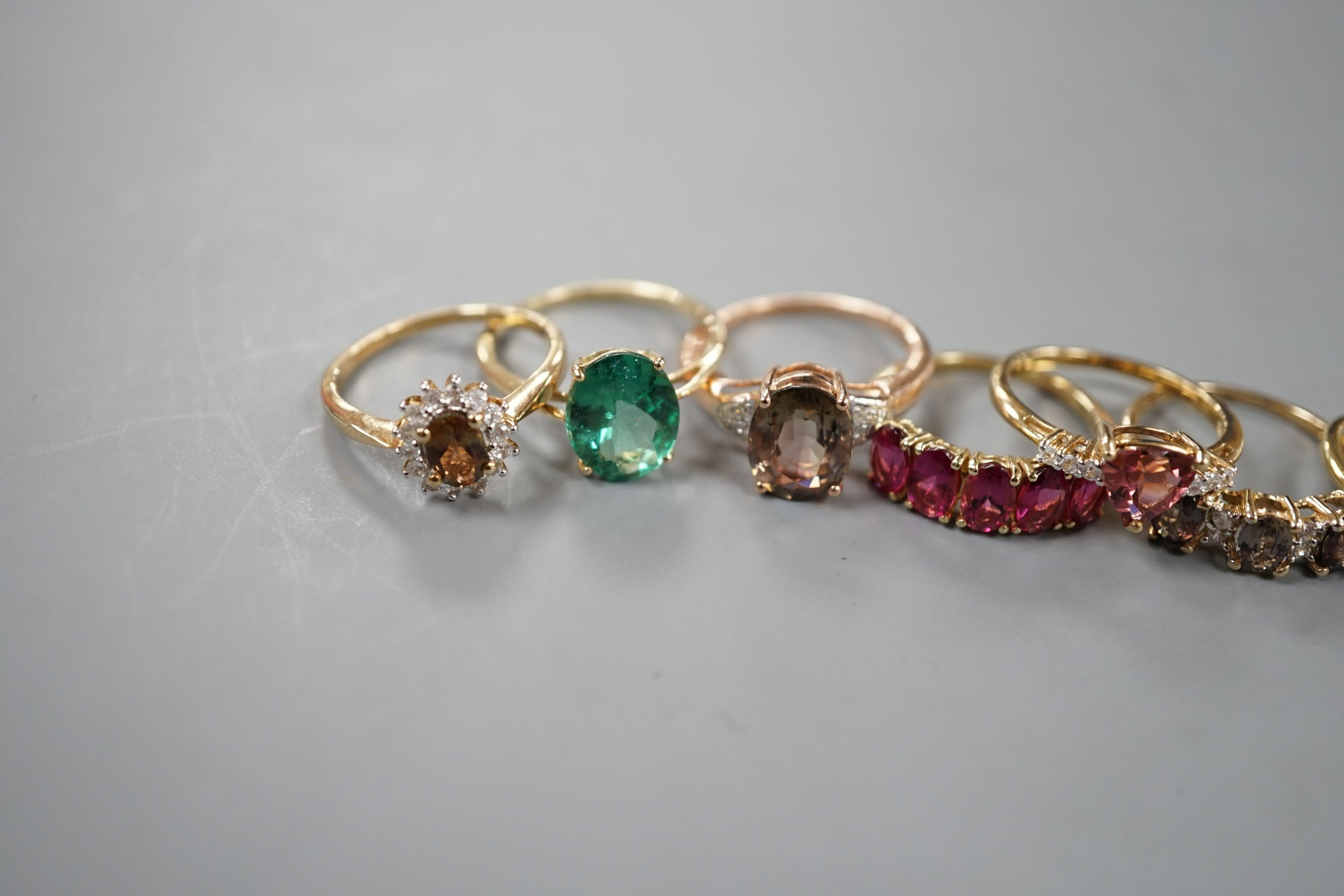 Seven assorted modern 9ct gold and gem set dress rings, including rubellite and a 14ct gold and garnet ring